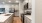 Spacious and well lit kitchen with wood floors and stainless steel appliances. 